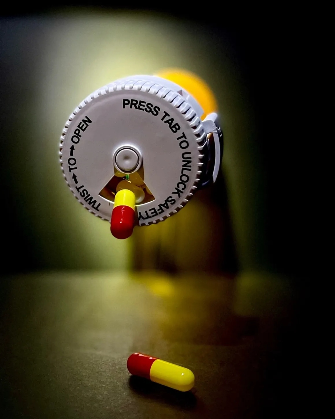 Pill bottle with capsules nearby