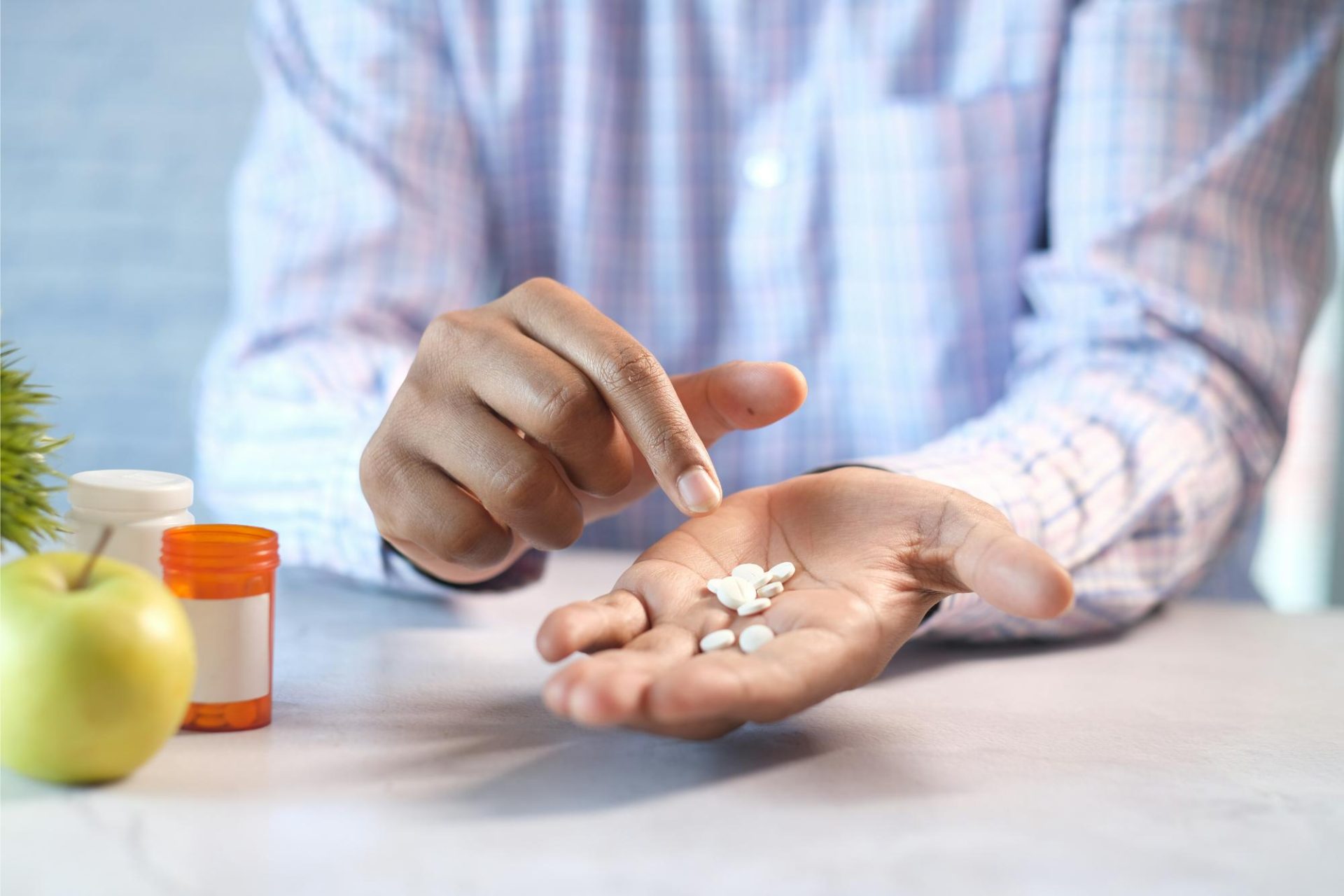Medication in hand: Person holding and counting prescription pills